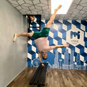 Paul Vinger, voice actor, at Museum of Illusions Chicago Paul Vinger photographed in a "one-finger handstand", with Glynna popping in from the "ceiling", at the Museum of Illusions, Chicago